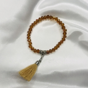 Bracelet ambre en perles de verre et pompon